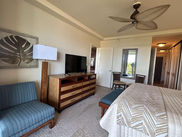 carpeted bedroom featuring a closet and ceiling fan