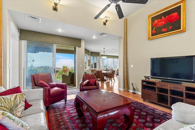 living room with visible vents, a ceiling fan, wood finished floors, and recessed lighting
