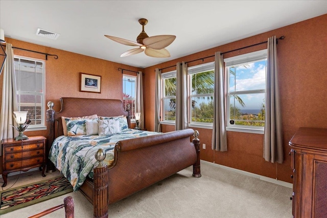 bedroom with baseboards, visible vents, light carpet, and ceiling fan