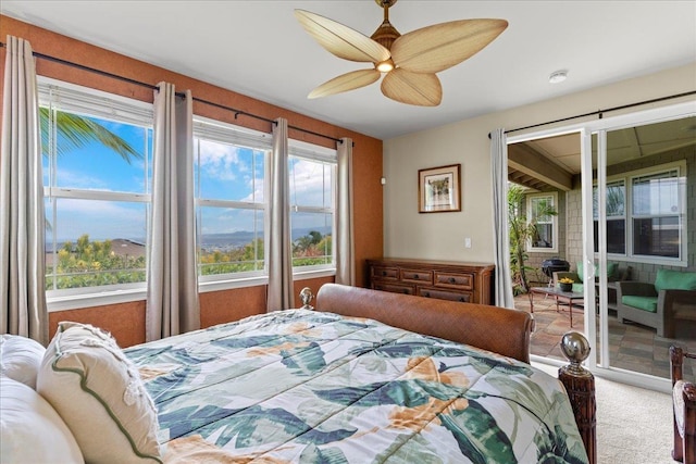 carpeted bedroom featuring ceiling fan and access to outside