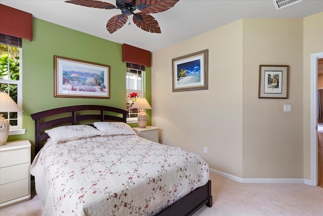 carpeted bedroom with baseboards, ceiling fan, and visible vents