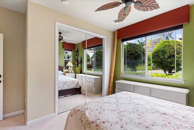 carpeted bedroom with a ceiling fan, baseboards, and a closet