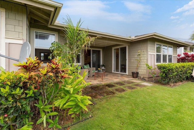 rear view of house with a patio area and a yard