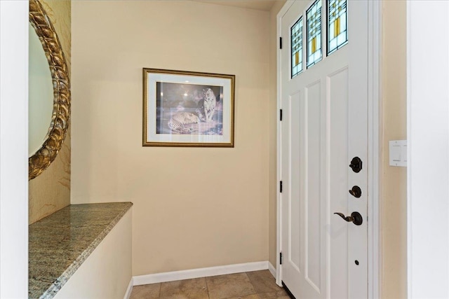 doorway to outside featuring baseboards