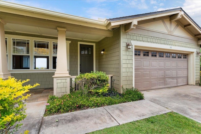 view of front of house featuring an attached garage, concrete driveway, and a porch