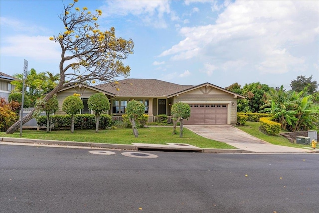 view of front of house featuring a garage, concrete driveway, and a front lawn