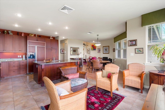 living room with recessed lighting, baseboards, and visible vents