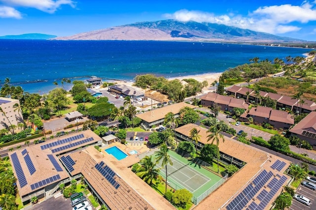 drone / aerial view featuring a water and mountain view