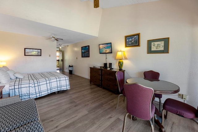 bedroom featuring hardwood / wood-style flooring, high vaulted ceiling, and ceiling fan