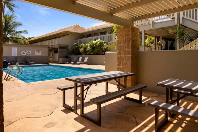 view of swimming pool featuring a patio area and a pergola