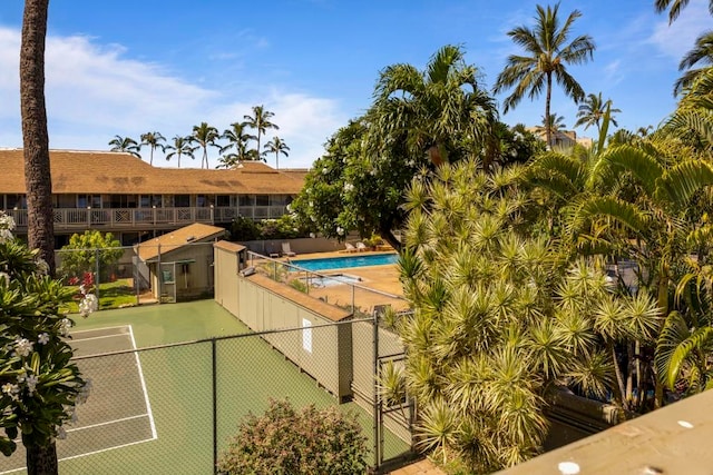 view of sport court with a community pool