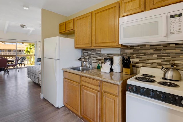 kitchen with sink, beamed ceiling, light hardwood / wood-style flooring, white appliances, and tasteful backsplash