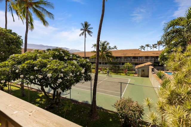 view of sport court with a mountain view and a fenced in pool