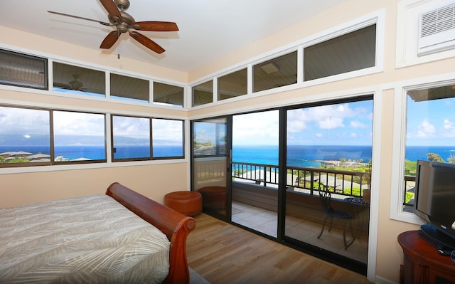 bedroom featuring access to outside and wood finished floors