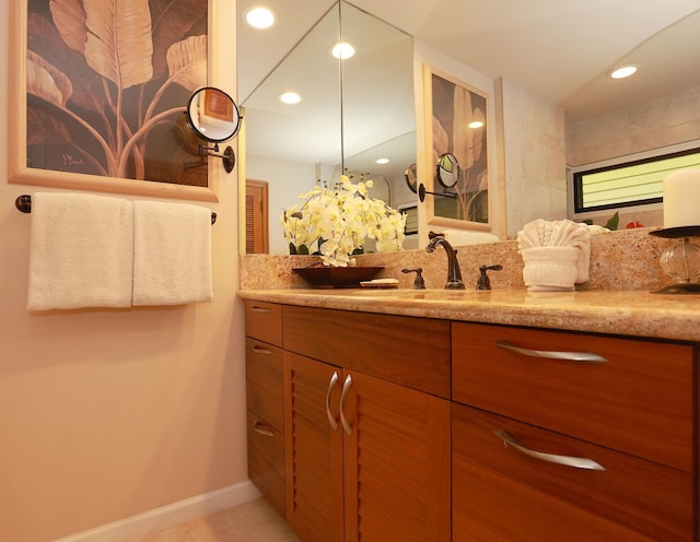 bathroom featuring baseboards, vanity, and recessed lighting