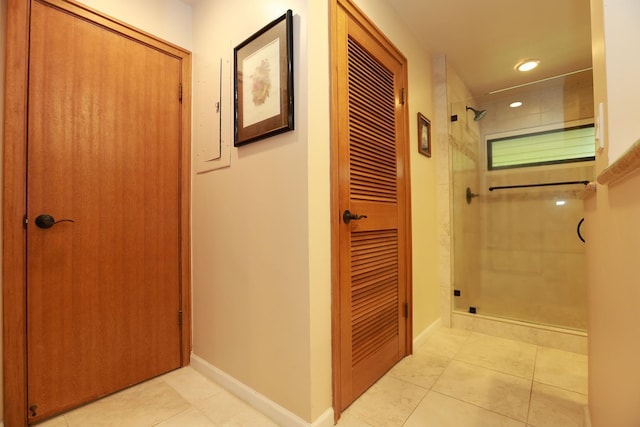 hallway featuring recessed lighting, light tile patterned flooring, and baseboards