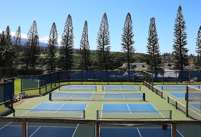 view of sport court featuring fence