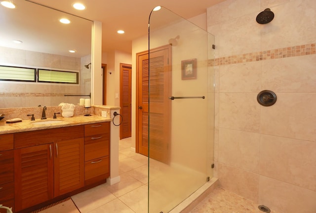 bathroom with tile patterned flooring, recessed lighting, vanity, tiled shower, and a closet