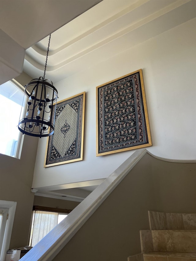 interior details with a chandelier and a raised ceiling