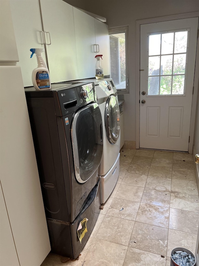 laundry area with cabinet space and separate washer and dryer