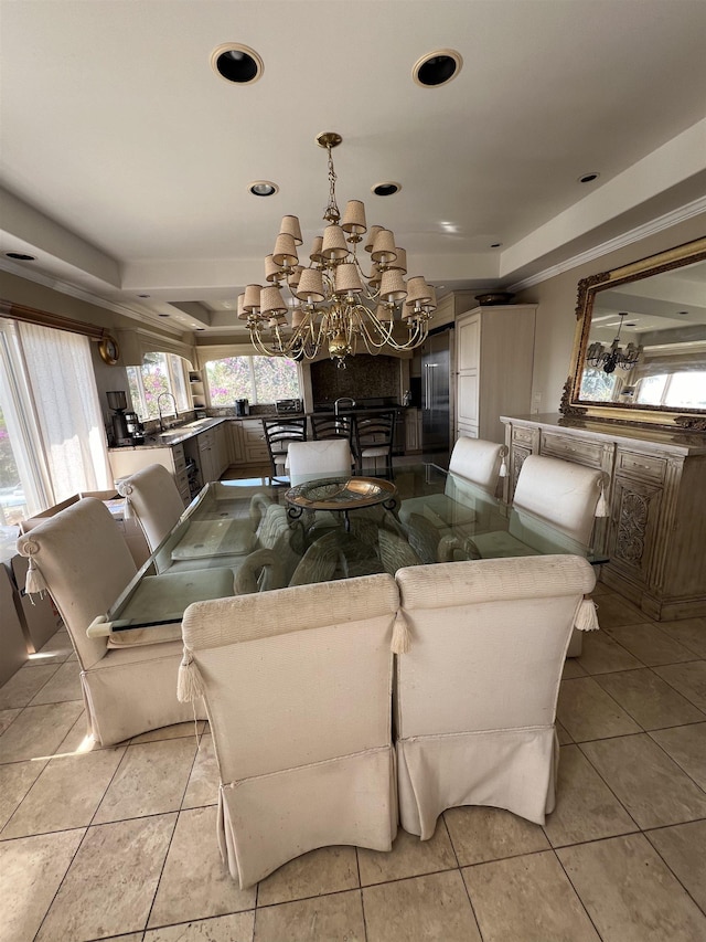 living area with light tile patterned floors, a notable chandelier, recessed lighting, and a tray ceiling