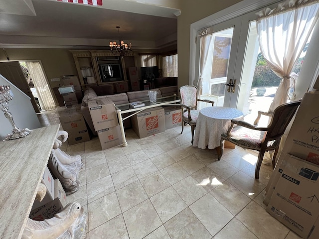 kitchen with light tile patterned floors, french doors, a notable chandelier, and hanging light fixtures