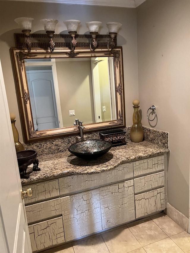 bathroom featuring tile patterned flooring, vanity, and baseboards