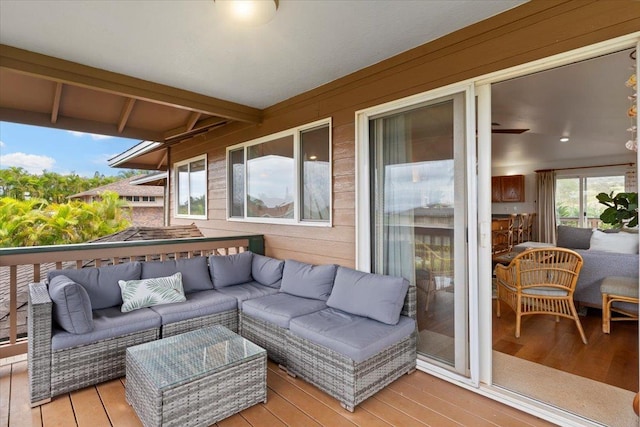 wooden deck with an outdoor living space