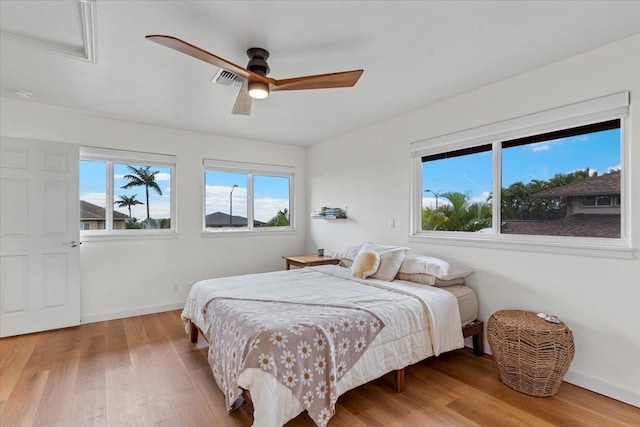 bedroom featuring hardwood / wood-style flooring and ceiling fan