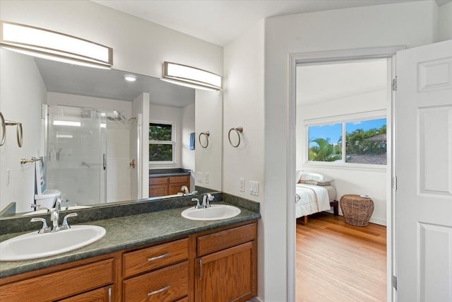 bathroom with walk in shower, toilet, vanity, and hardwood / wood-style flooring