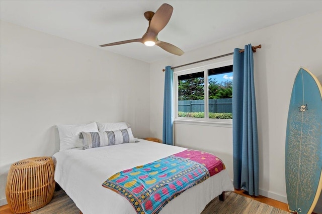 bedroom with ceiling fan and hardwood / wood-style flooring