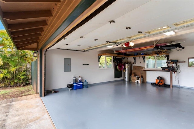 garage featuring gas water heater, a garage door opener, and electric panel