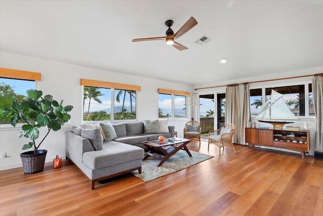 living room with ceiling fan and light hardwood / wood-style floors