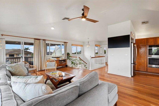 living room featuring ceiling fan and light hardwood / wood-style flooring