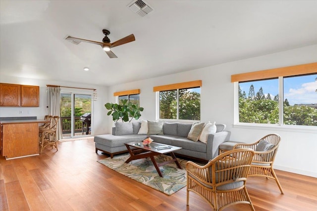 living room with ceiling fan and light wood-type flooring