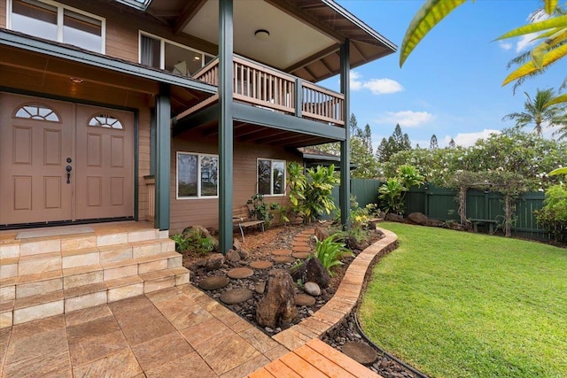 property entrance with a yard and a balcony