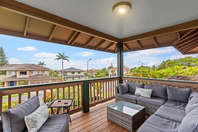 wooden terrace with an outdoor living space