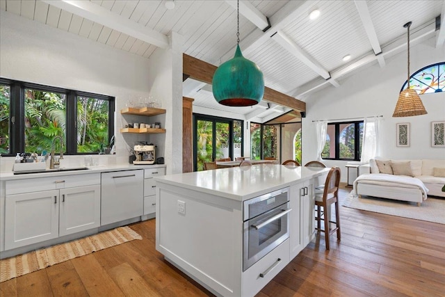 3291 Waileia Pl, Kihei, HI 96753 - kitchen featuring dishwasher, a sink, open floor plan, light wood finished floors, and wooden ceiling with exposed beams