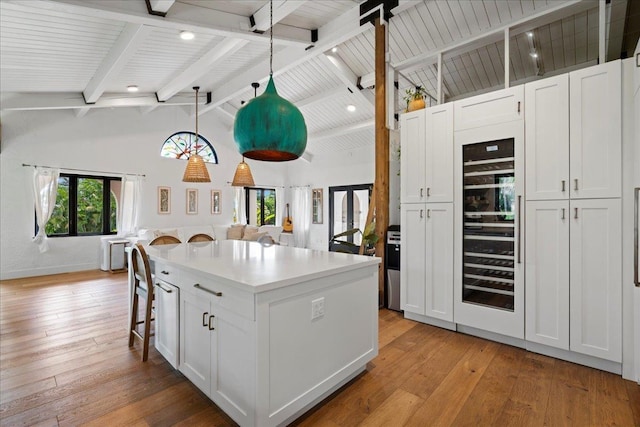 3291 Waileia Pl, Kihei, HI 96753 - kitchen featuring beverage cooler, light wood-style flooring, white cabinetry, and wood ceiling