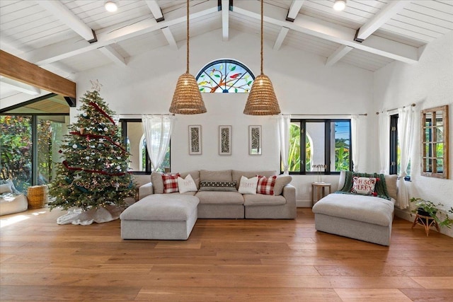 living room with hardwood / wood-style floors, beam ceiling, and high vaulted ceiling