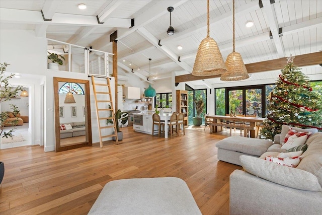 living room with beamed ceiling, light wood-type flooring, high vaulted ceiling, and french doors