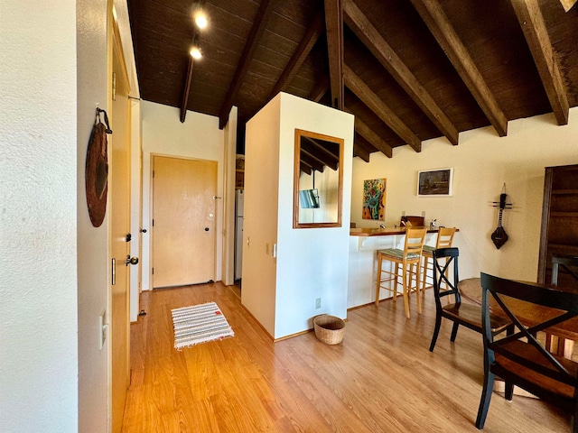 interior space featuring hardwood / wood-style flooring, lofted ceiling with beams, and wooden ceiling