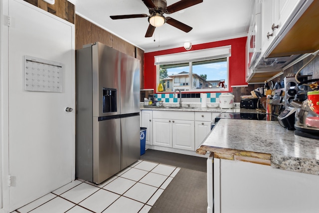 kitchen with backsplash, sink, ceiling fan, stainless steel fridge, and white cabinetry