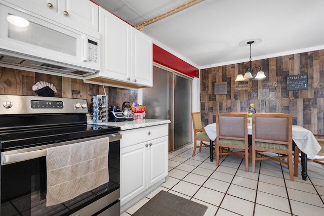 kitchen featuring white cabinets, pendant lighting, stainless steel electric range, and an inviting chandelier