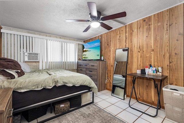 tiled bedroom featuring a textured ceiling, ceiling fan, cooling unit, and wood walls