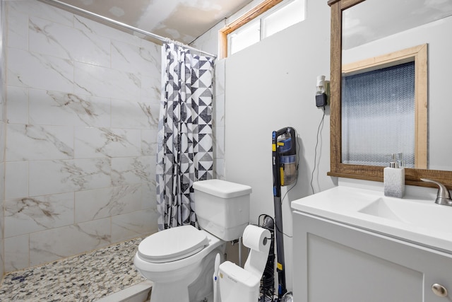 bathroom with toilet, vanity, and walk in shower