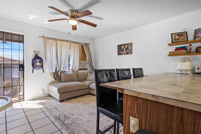 living room with ceiling fan and light tile patterned floors