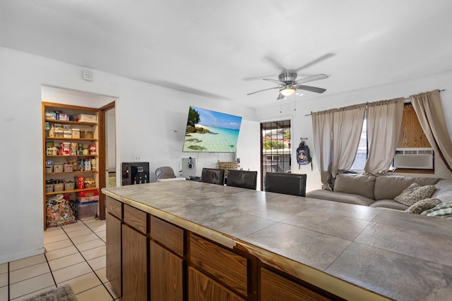 kitchen featuring tile countertops, ceiling fan, cooling unit, and light tile patterned floors