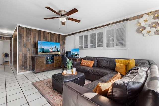 tiled living room with wood walls, ceiling fan, and ornamental molding