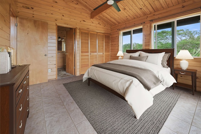 bedroom featuring wood walls, light tile patterned floors, wooden ceiling, ceiling fan, and vaulted ceiling with beams